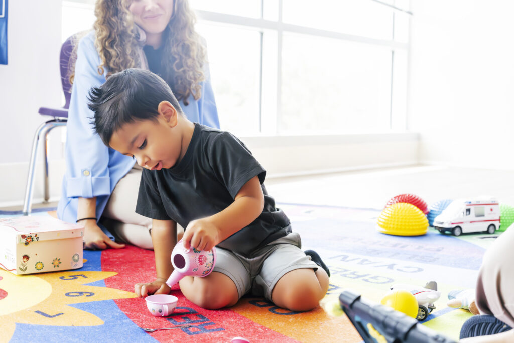 ABA therapist working with kid in an ABA session