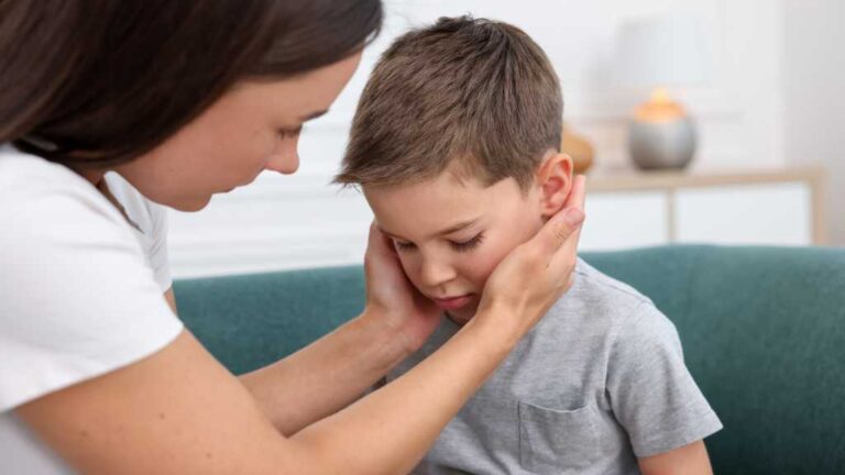 Parent comforting overwhelmed child – understanding the autism window of tolerance.