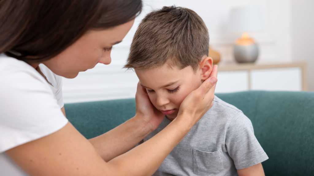 Parent comforting overwhelmed child – understanding the autism window of tolerance.