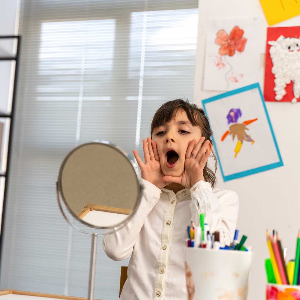 Child practicing vocal sounds in a playful, art-filled room