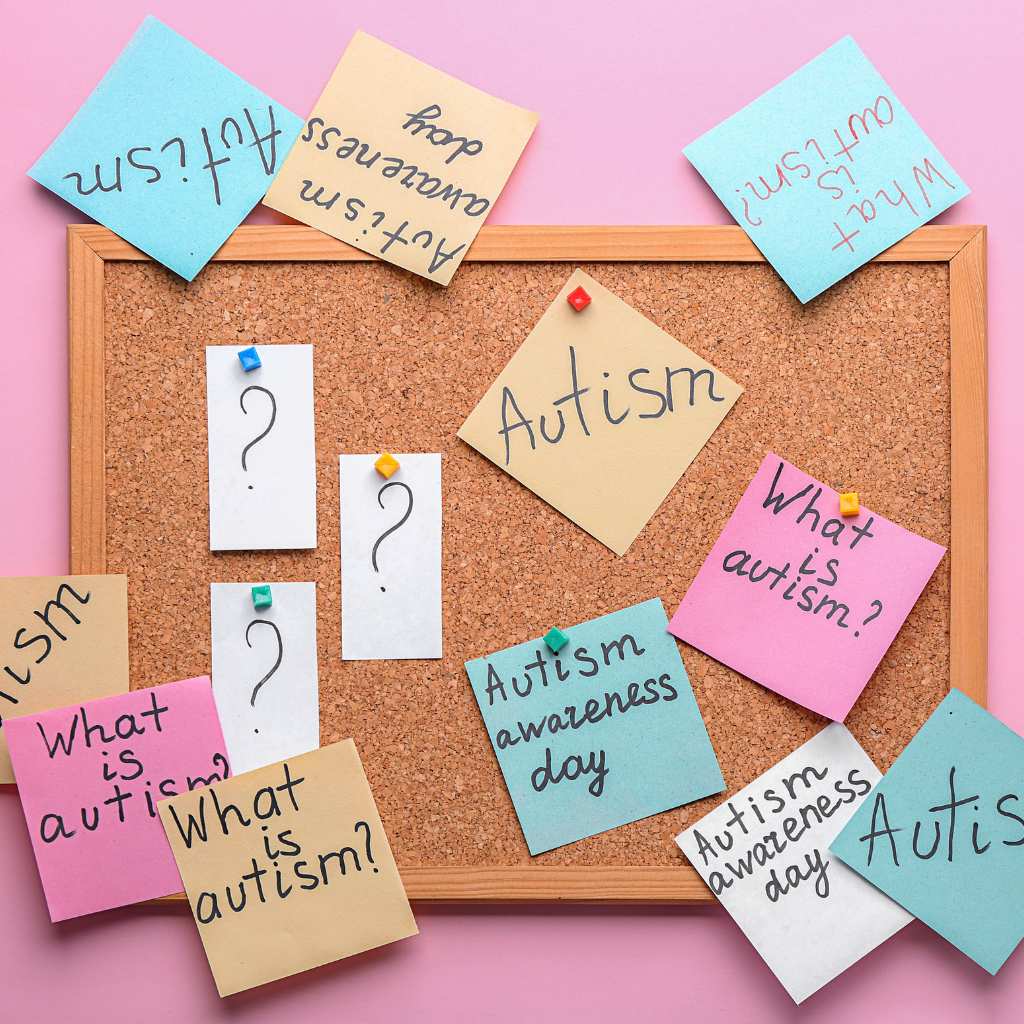 Cluster of pastel sticky notes around a board, all focused on autism awareness