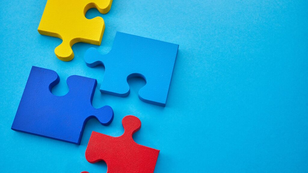 May Awareness Days. Puzzle pieces over a blue background