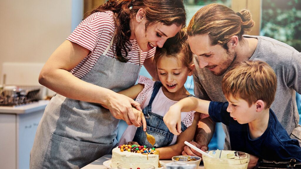 Parent supporting children as they make choices during a family baking activity