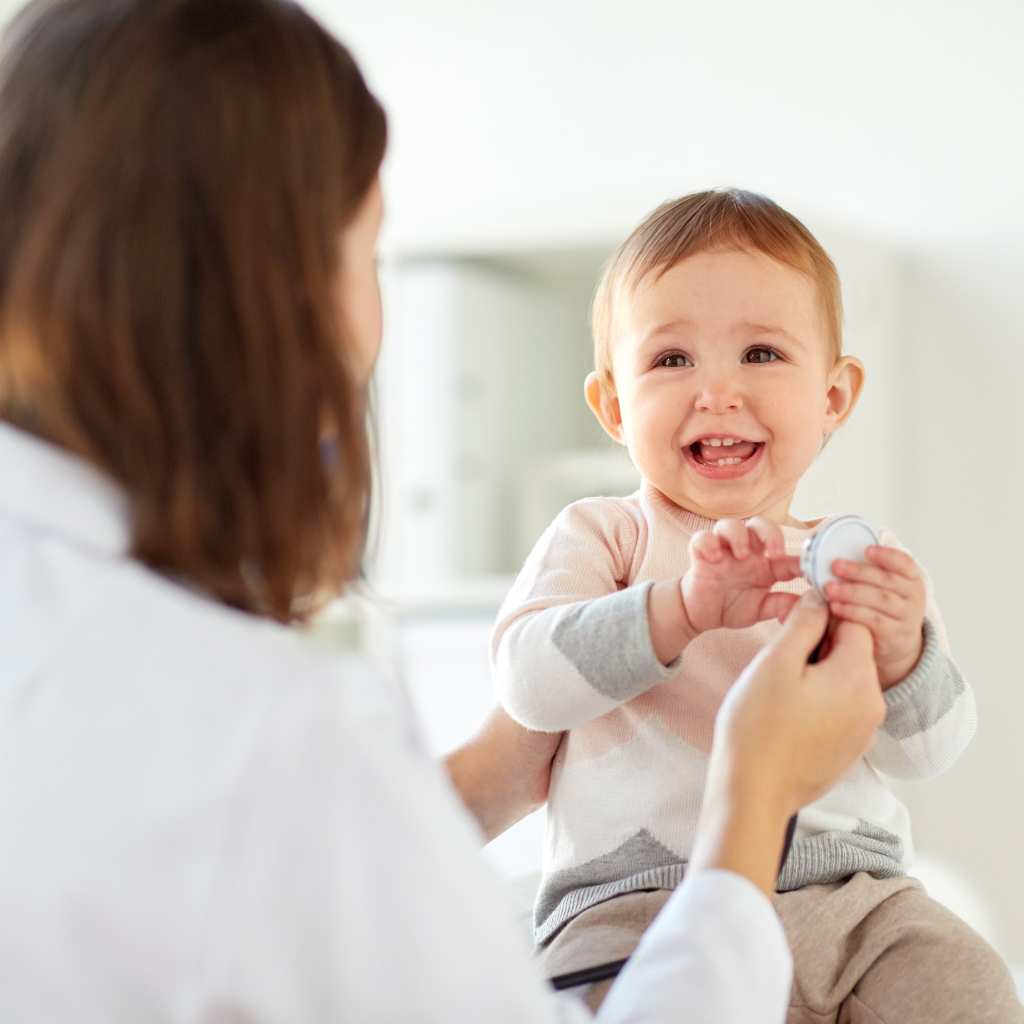 Pediatrician examining a toddler's chest during a checkup