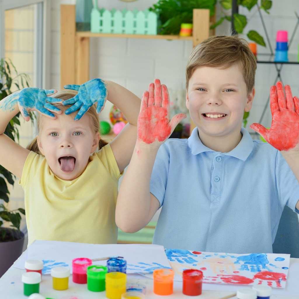 Children engaging in hands-on sensory play with paint, illustrating sensory input and emotional safety in the autism nervous system.