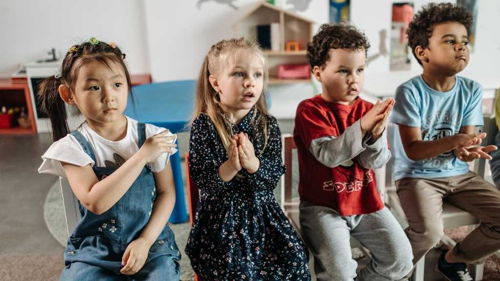 Young children participating in a group activity, illustrating emotional regulation and the window of tolerance in autistic children’s nervous systems.